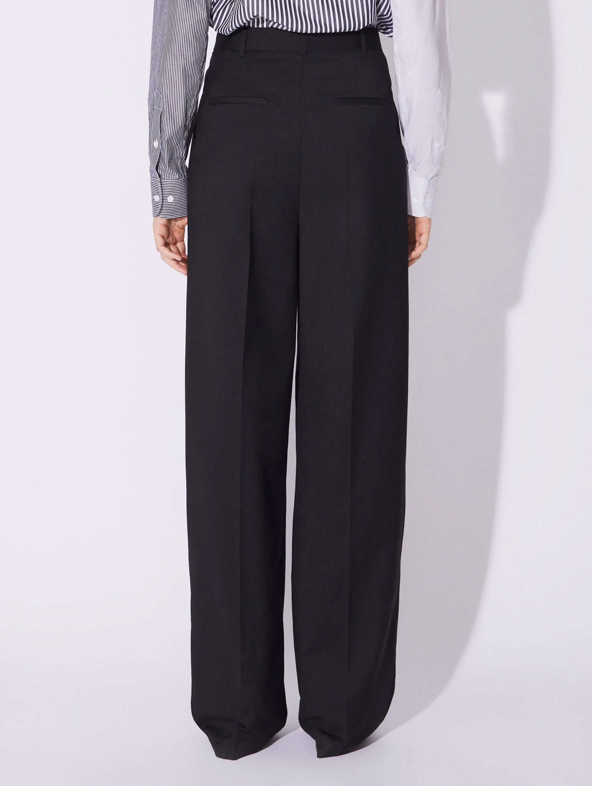 Black stretch wool high waisted pleated trousers Reflective accents